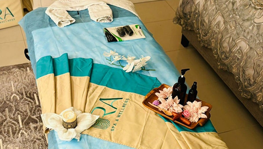 Relaxing massage setup at Ora Spa Home Service, Riyadh, Riyadh Province, SA, featuring oils and flowers.