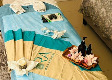 Relaxing massage setup at Ora Spa Home Service, Riyadh, Riyadh Province, SA, featuring oils and flowers.