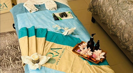 Relaxing massage setup at Ora Spa Home Service, Riyadh, Riyadh Province, SA, featuring oils and flowers.