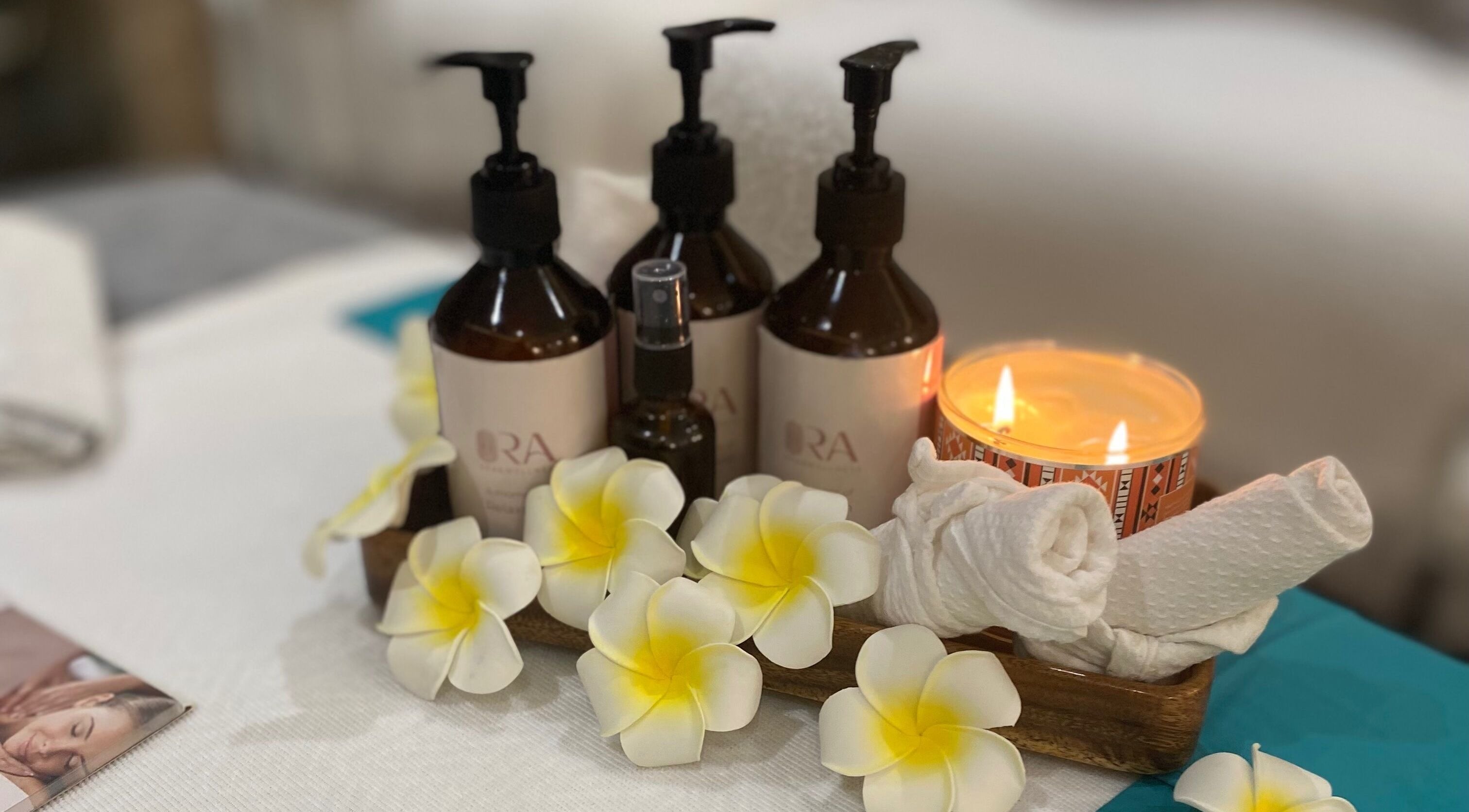 Ora Spa Home Service essentials with flowers and candle, Riyadh, Riyadh Province, SA.