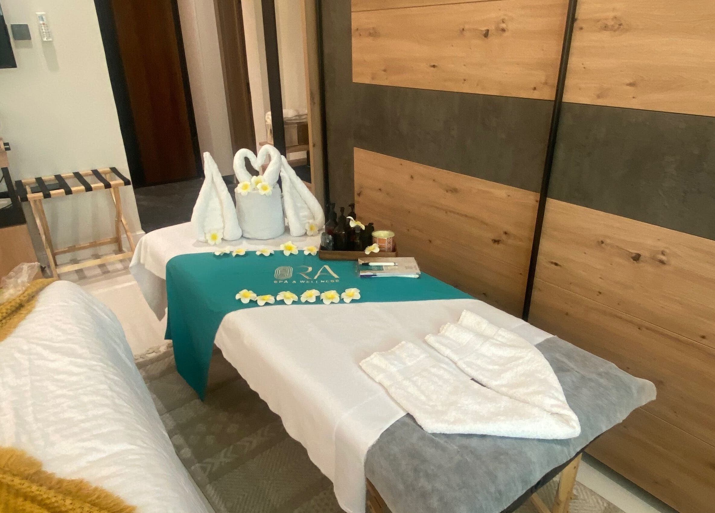 Relaxing spa setup at Ora Spa Home Service (Ladies Only), Riyadh, Riyadh Province, SA. Towel swans and flowers adorn.