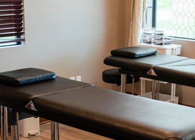 Relaxing treatment room at The Facial And Wellness Society, The Woodlands, Texas, US, with comfortable spa beds.