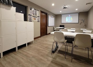 Modern training room at The Facial And Wellness Society, The Woodlands, Texas, US with presentation screen.
