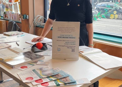 LZ Massage Therapies info table at Whitley Bay, England, GB, showcasing wellness pamphlets and contact details.