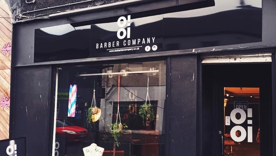 Front view of Oioi Barber Company South Street in Perth, GB, showcasing modern black signage and window decor.