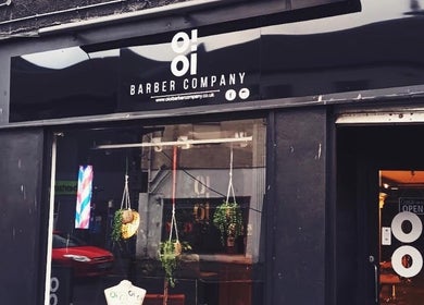 Front view of Oioi Barber Company South Street in Perth, GB, showcasing modern black signage and window decor.