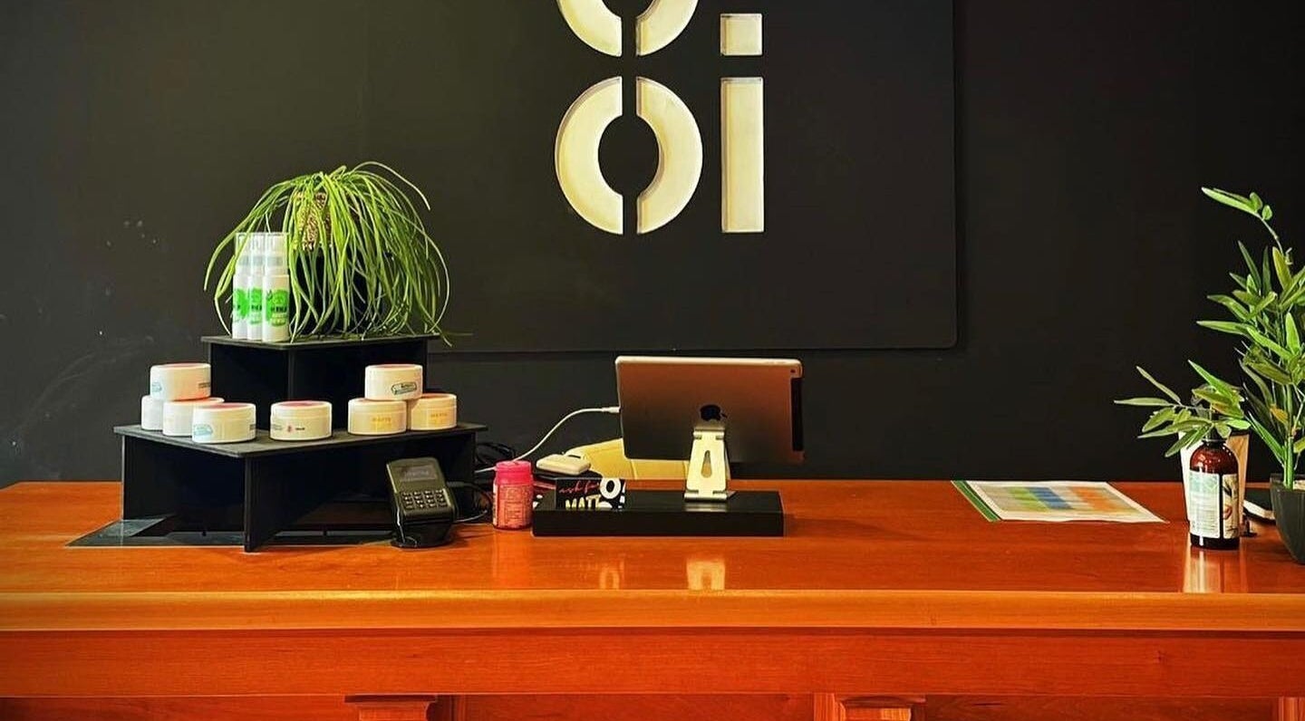Oioi Barber Company South Street, Perth, GB, modern reception decor with products displayed on a wooden countertop.
