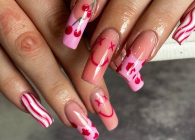 Vibrant cherry-themed nail art at Hair & Beauty by Lacey & Monique, Huddersfield, England, GB.