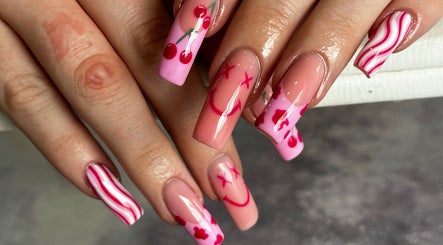 Vibrant cherry-themed nail art at Hair & Beauty by Lacey & Monique, Huddersfield, England, GB.