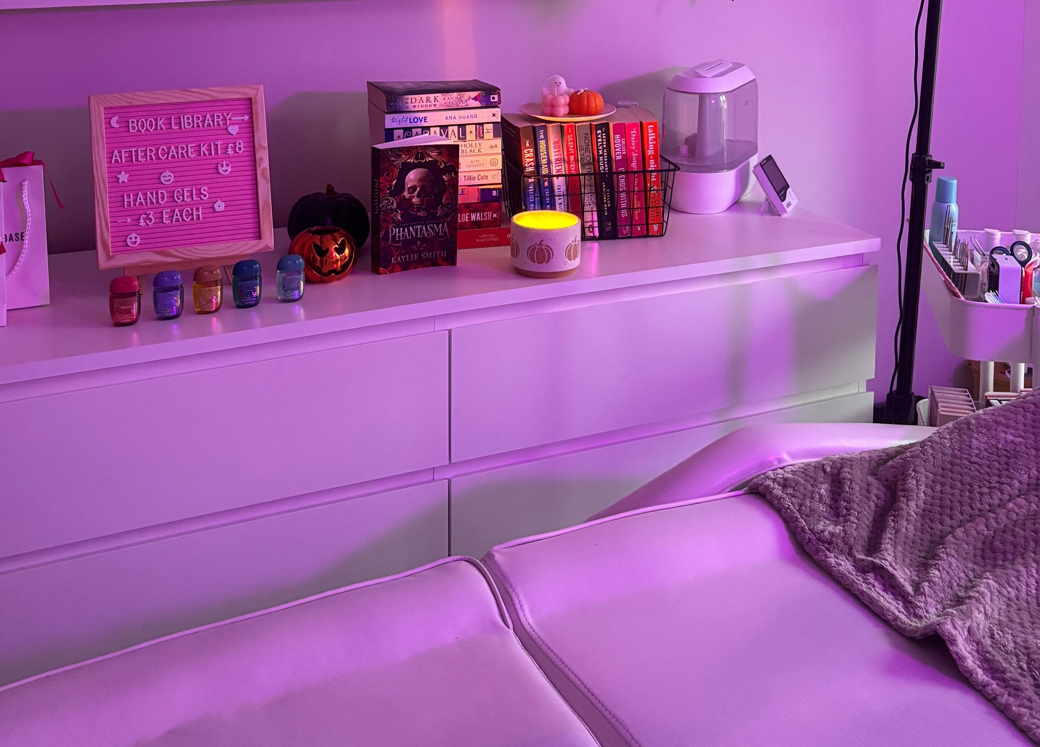 Relaxing treatment room setup at Lashes by Molly in Warrington, GB, featuring products and ambient lighting.