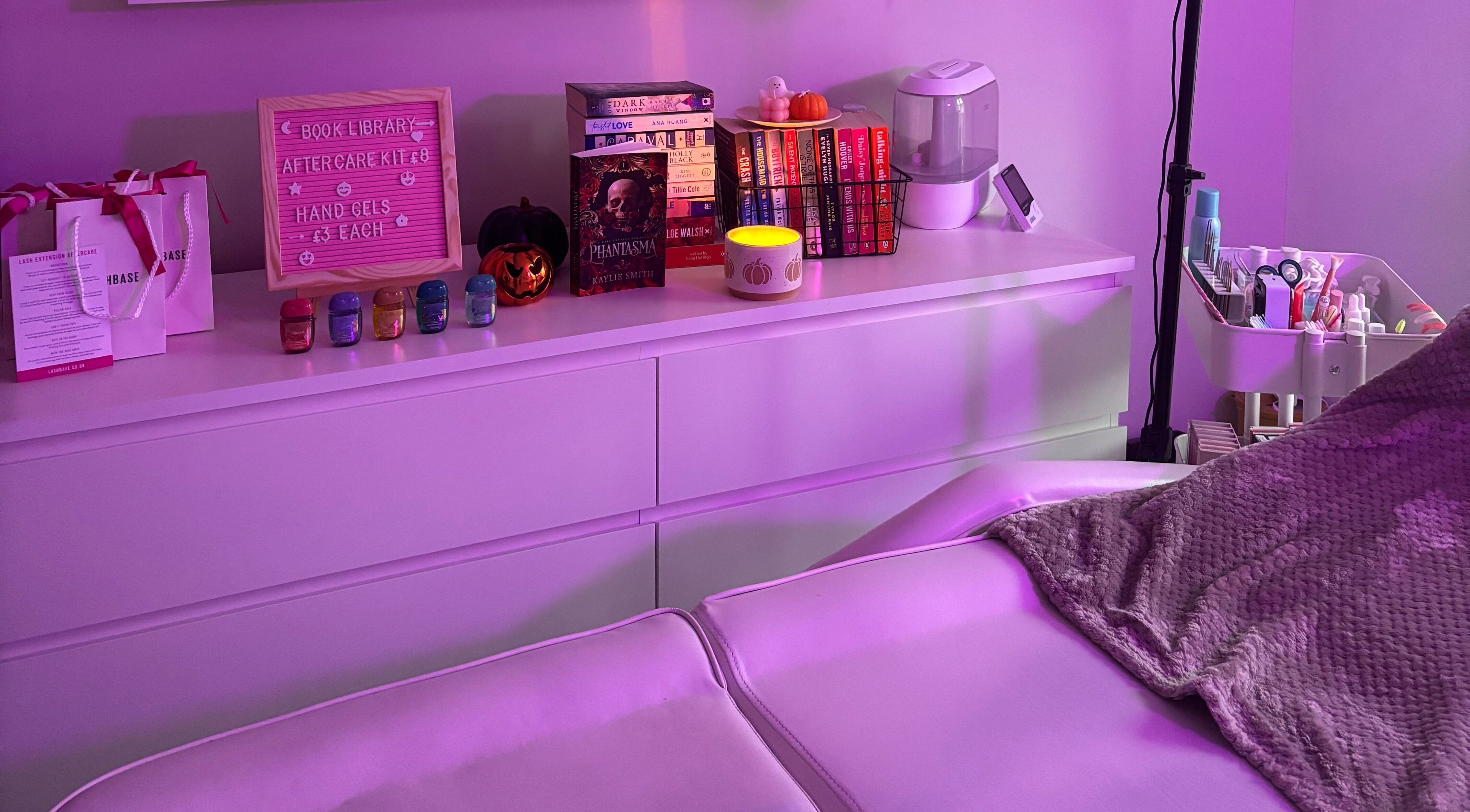 Relaxing treatment room setup at Lashes by Molly in Warrington, GB, featuring products and ambient lighting.