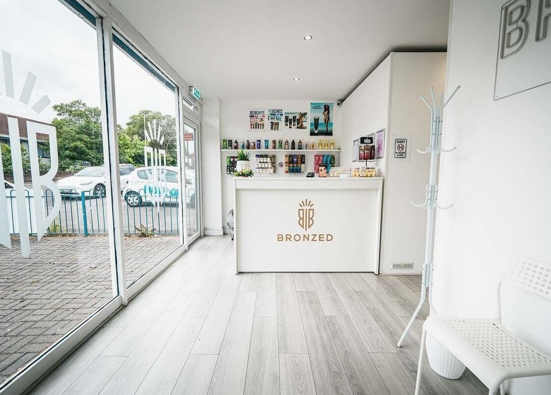 Reception area of Bronzed of Broadstone in Poole, England, GB featuring sleek modern decor and product displays.