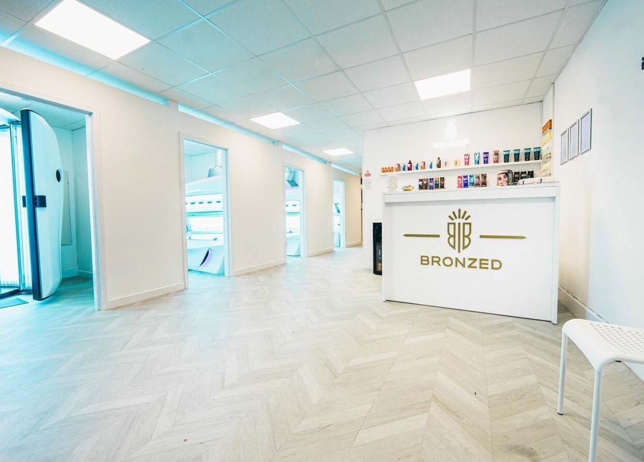 Spacious, modern interior of Bronzed of Broadstone in Poole, England, GB featuring tanning booths and reception area.