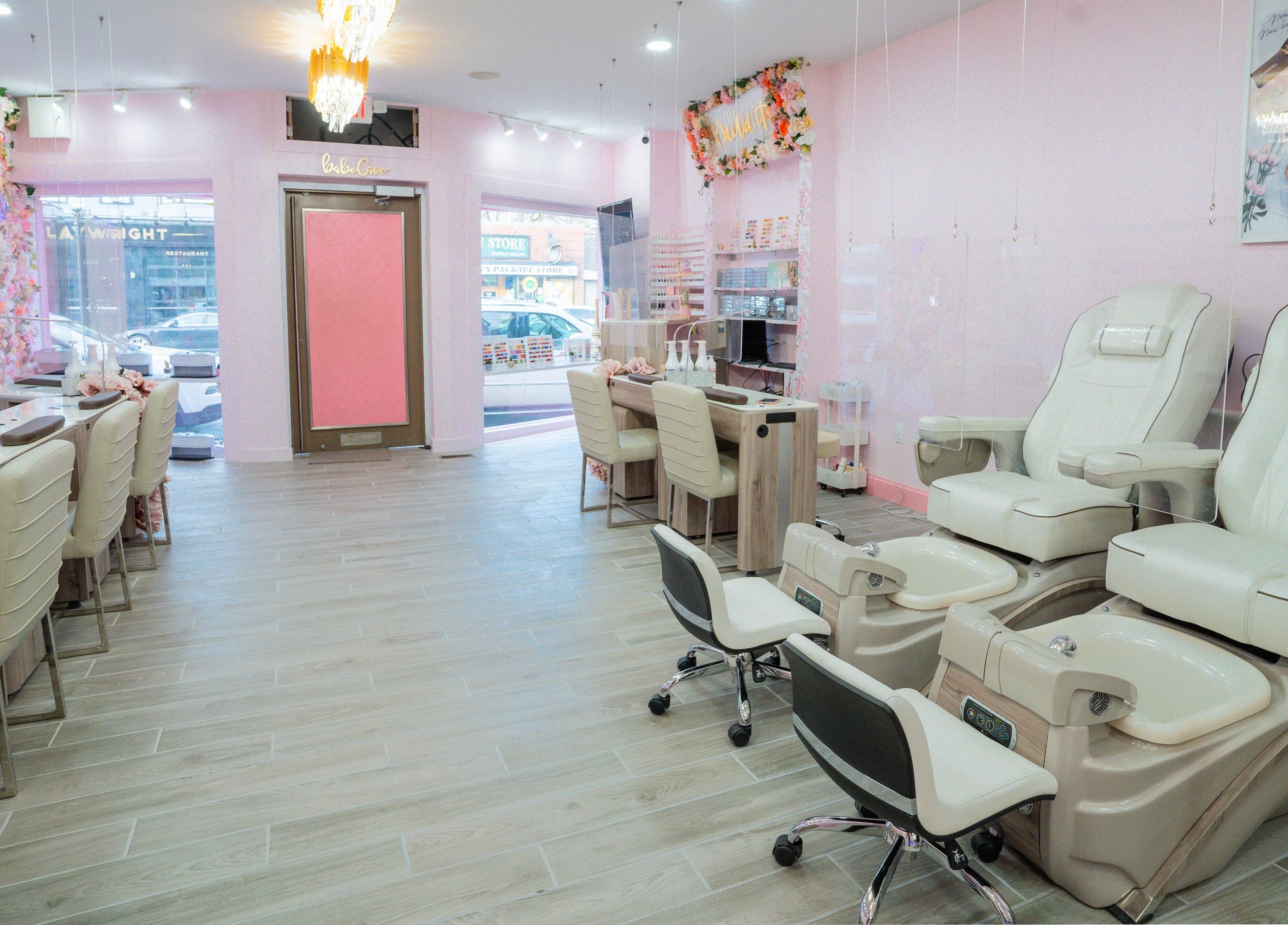 Bright, modern nail salon interior at Naild It Southie in South Boston, Massachusetts, US with plush pedicure chairs.