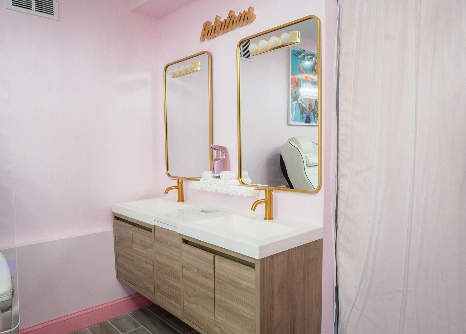 Stylish vanity with dual mirrors at Naild It Southie in South Boston, Massachusetts, US.