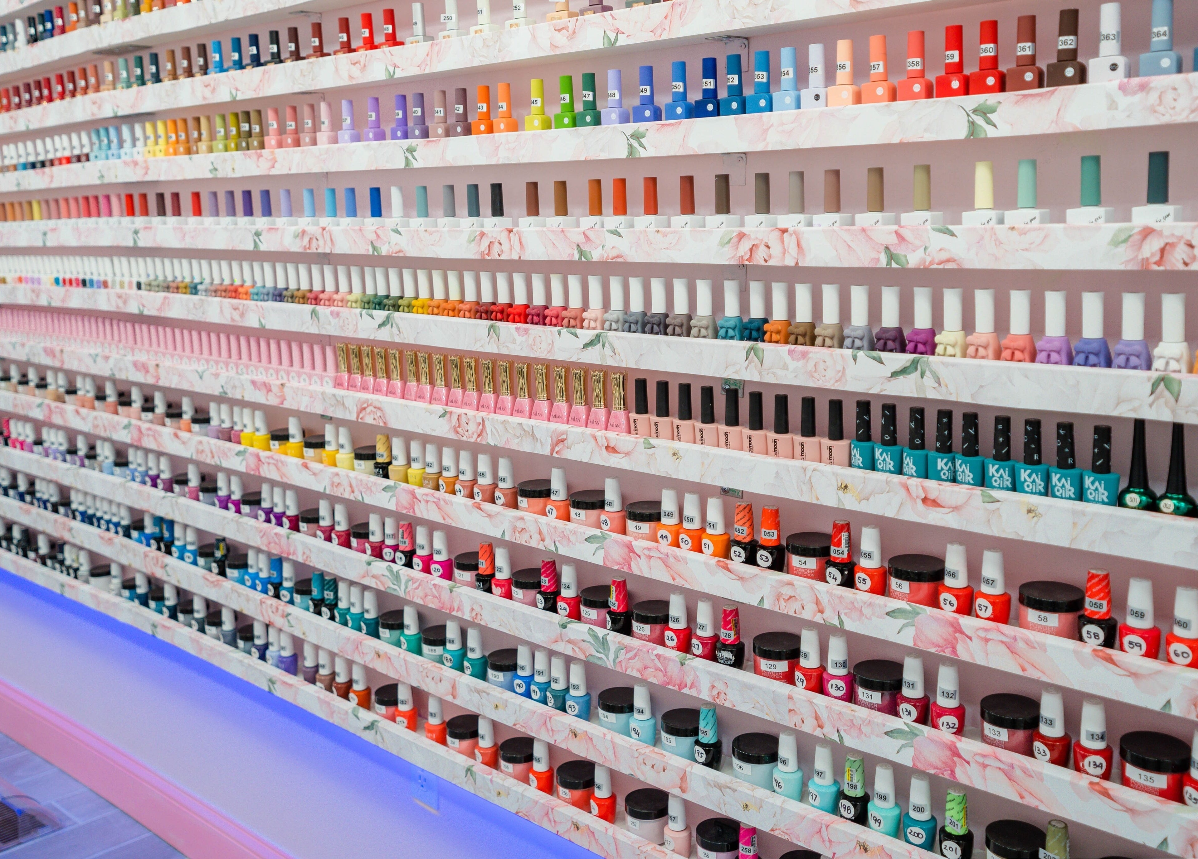 Colorful nail polish wall display at Naild It Southie, South Boston, Massachusetts, US.