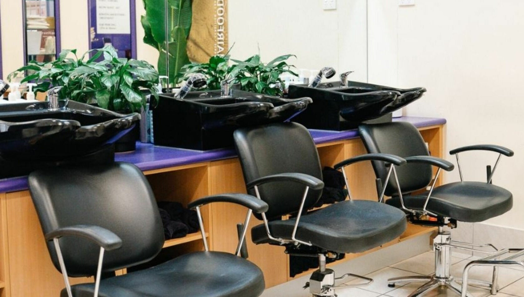Modern salon chairs and wash basins at Meraki Curlz, Mount Sheridan, Queensland, AU.