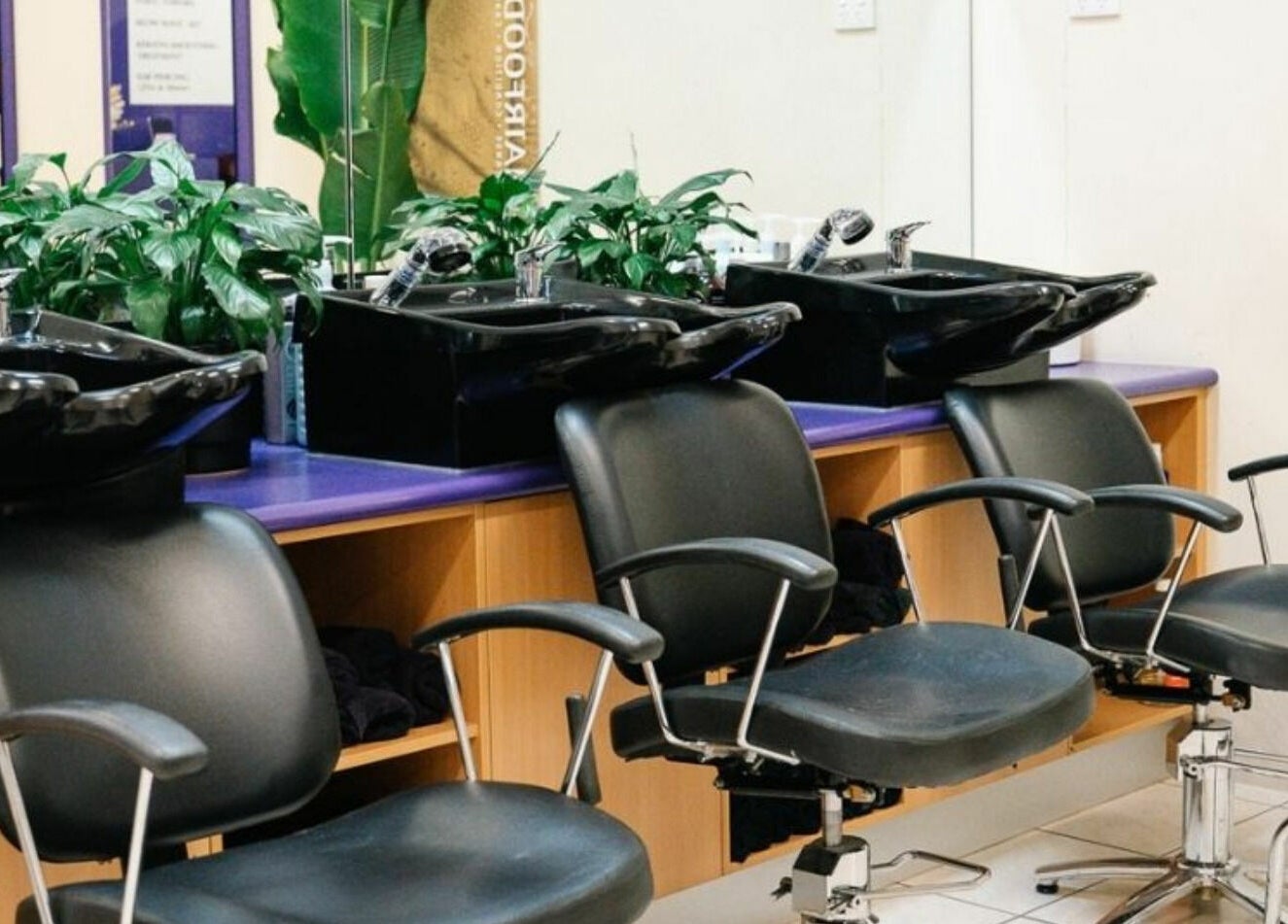 Modern salon chairs and wash basins at Meraki Curlz, Mount Sheridan, Queensland, AU.