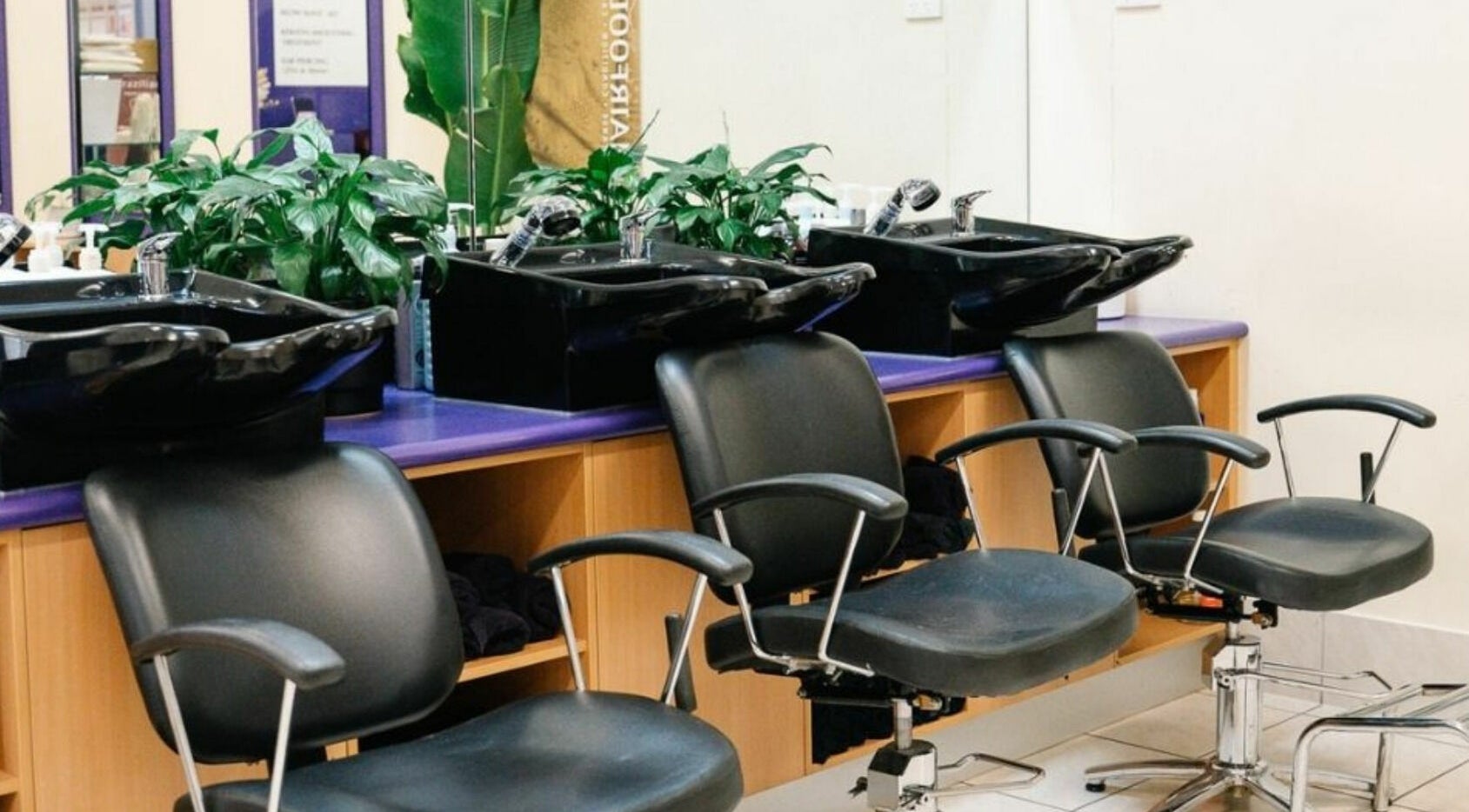 Modern salon chairs and wash basins at Meraki Curlz, Mount Sheridan, Queensland, AU.
