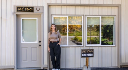 HBL Studio - Lauren Gibson exterior in Millbrook, Ontario, CA with welcoming entrance and parking sign.