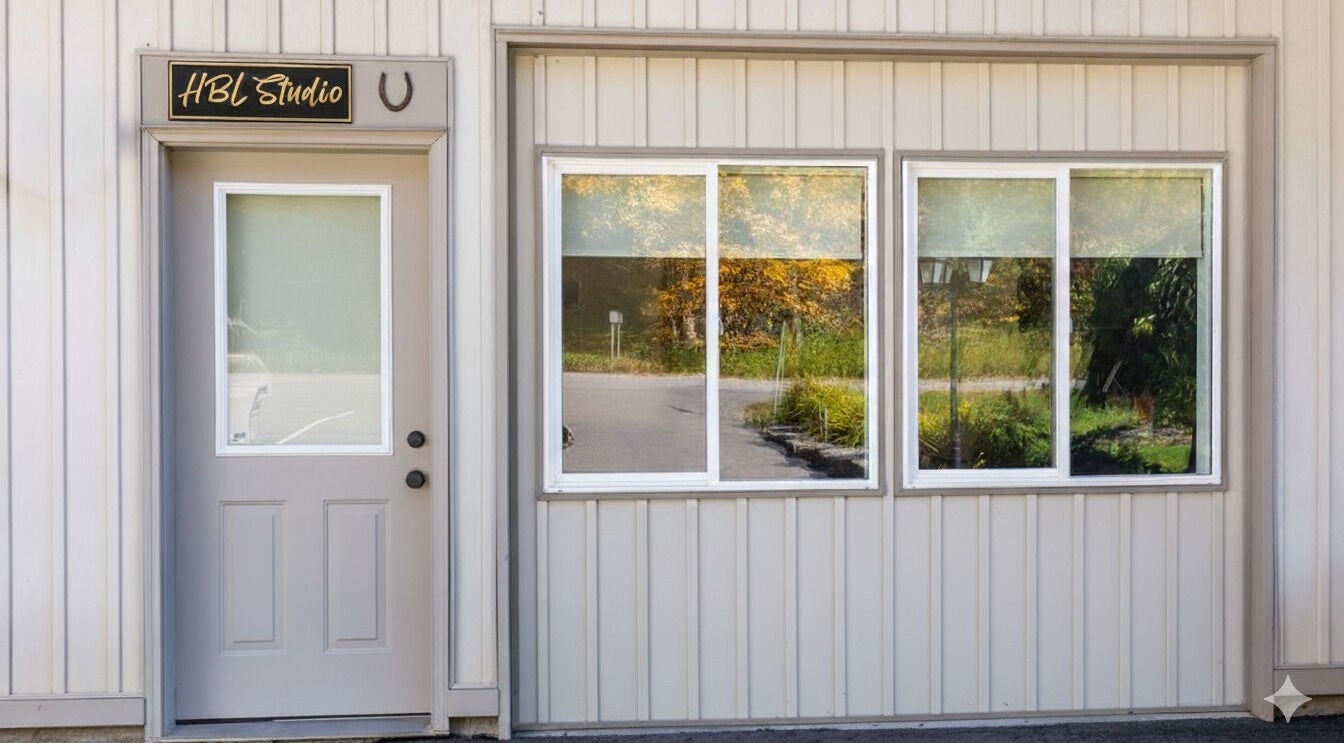 Entrance of HBL Studio - Lauren Gibson in Millbrook, Ontario, CA with stylish door and reflective windows.