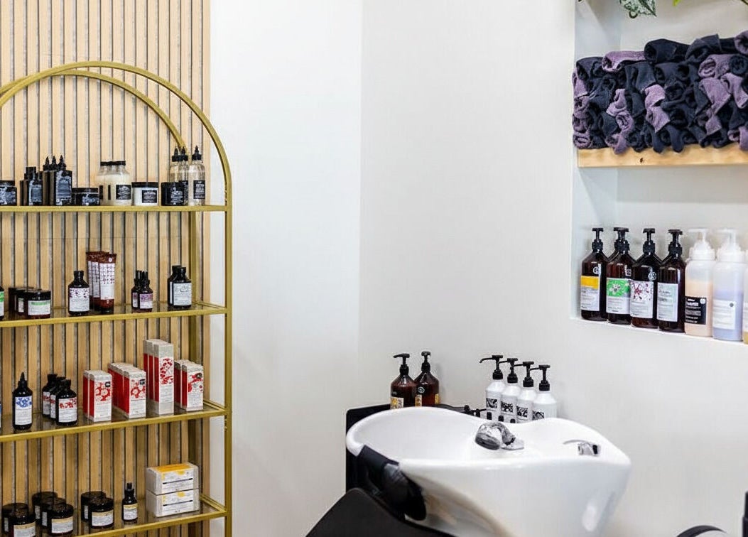 HBL Studio - Lauren Gibson in Millbrook, Ontario, CA: sleek hair washing station with stylish product shelf.