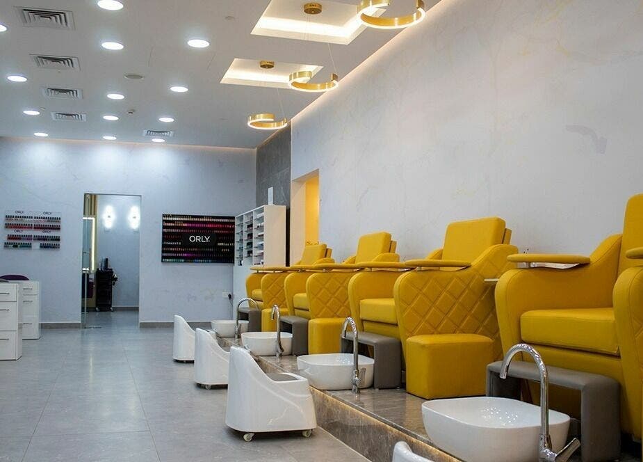 Feel pampered at Feels Beauty Lounge and Spa, Abu Dhabi, AE with luxurious yellow pedicure chairs and serene ambiance.