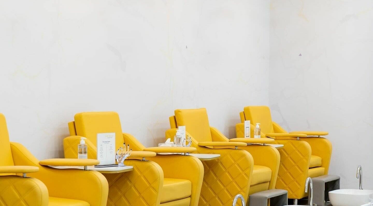 Luxurious yellow chairs at Feels Beauty Lounge and Spa, Abu Dhabi, AE ready for pedicure treatments.