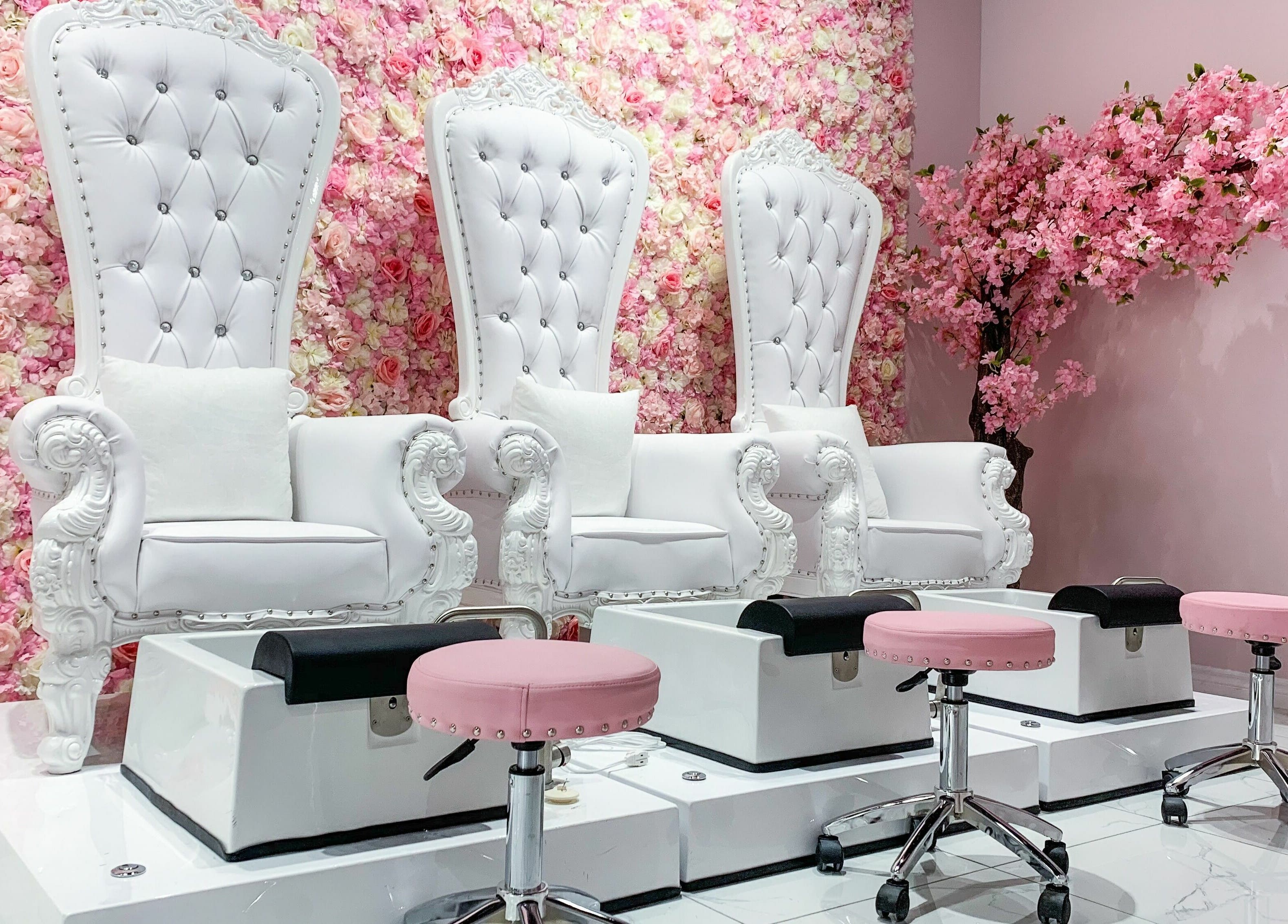 Luxurious pedicure chairs against floral wall in Goddess Salon, Toronto, Ontario, CA, enhancing serene ambiance.