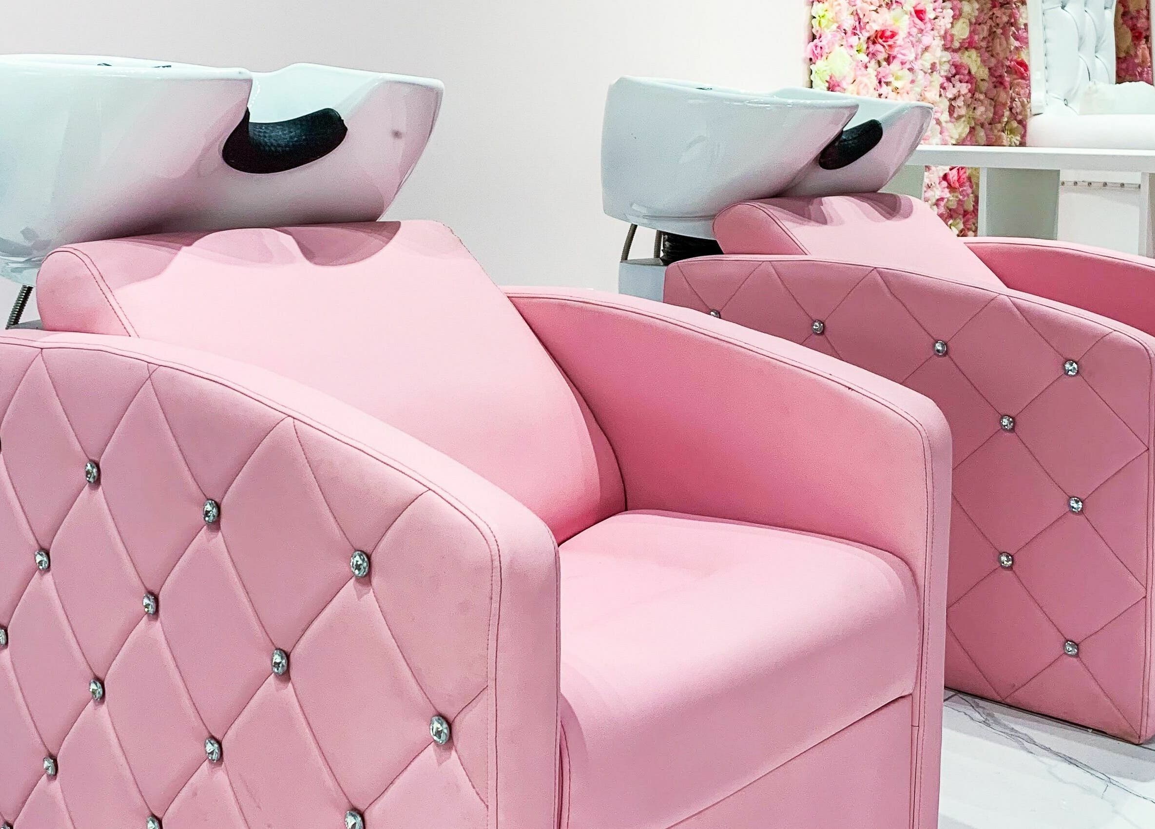 Luxury pink salon chairs at Goddess Salon, Toronto, Ontario, CA offer comfort and style for hair treatments.