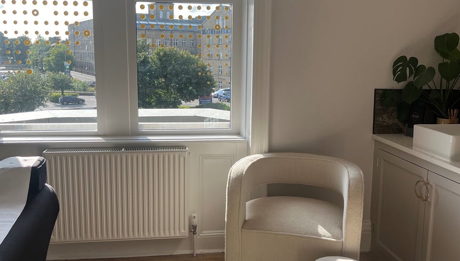 Cozy beauty therapy room at BEAUTY RACK, Skipton, England, GB with a comfy chair and lush greenery.