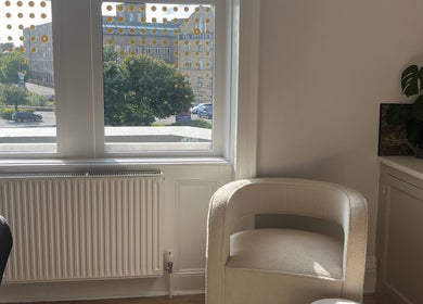 Cozy beauty therapy room at BEAUTY RACK, Skipton, England, GB with a comfy chair and lush greenery.
