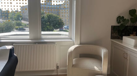 Cozy beauty therapy room at BEAUTY RACK, Skipton, England, GB with a comfy chair and lush greenery.