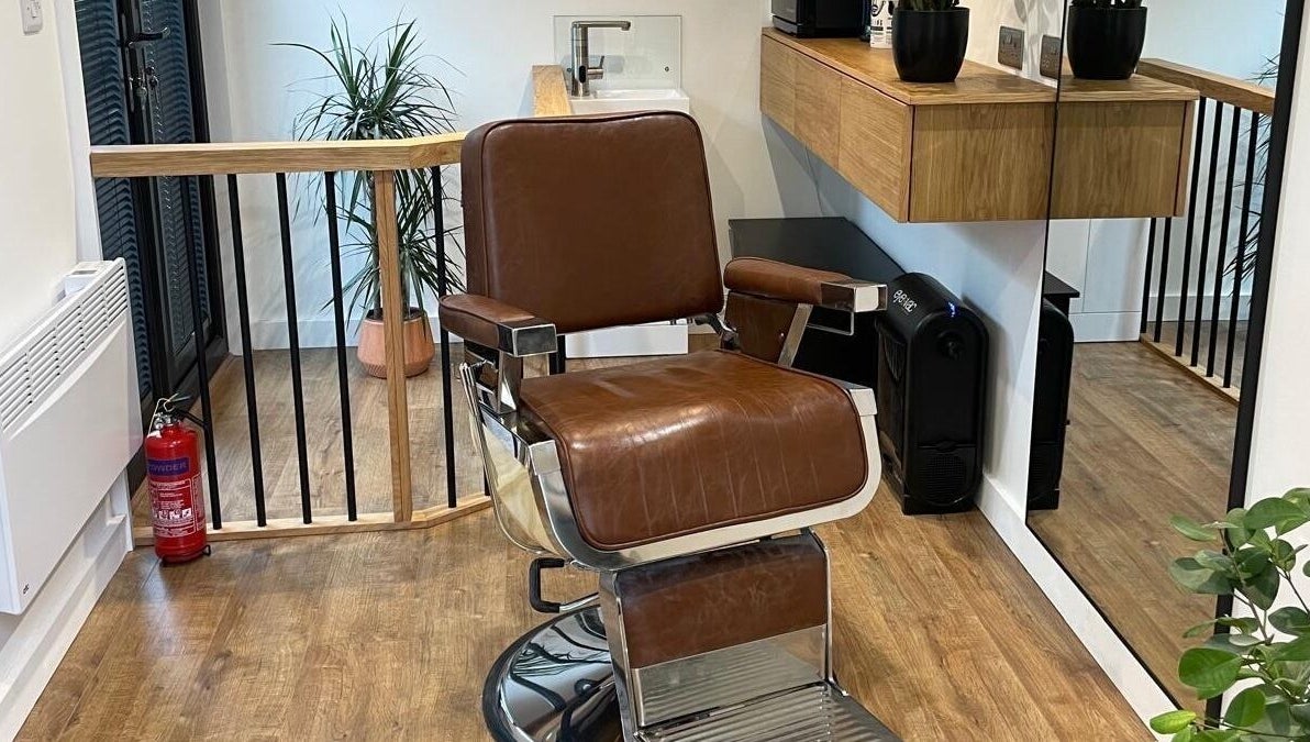 Luxurious barber chair at Ridgeway Barbers in Newport, Wales, GB, showcasing stylish interior and sleek design.