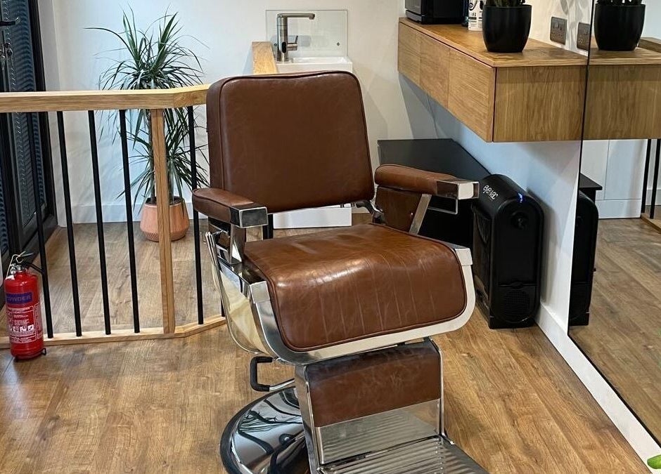Luxurious barber chair at Ridgeway Barbers in Newport, Wales, GB, showcasing stylish interior and sleek design.
