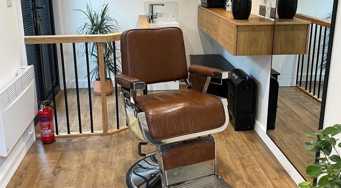 Luxurious barber chair at Ridgeway Barbers in Newport, Wales, GB, showcasing stylish interior and sleek design.