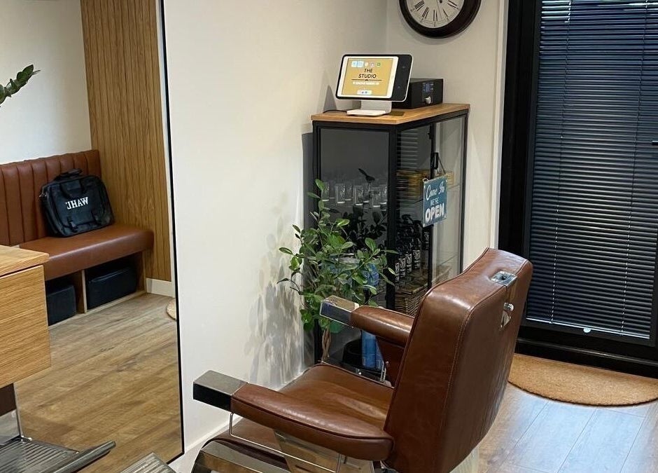 Modern barber chair at Ridgeway Barbers in Newport, Wales, GB, showcasing a sleek and welcoming interior.