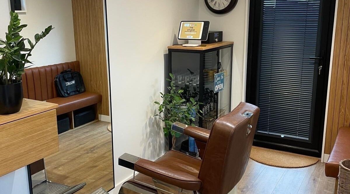 Modern barber chair at Ridgeway Barbers in Newport, Wales, GB, showcasing a sleek and welcoming interior.