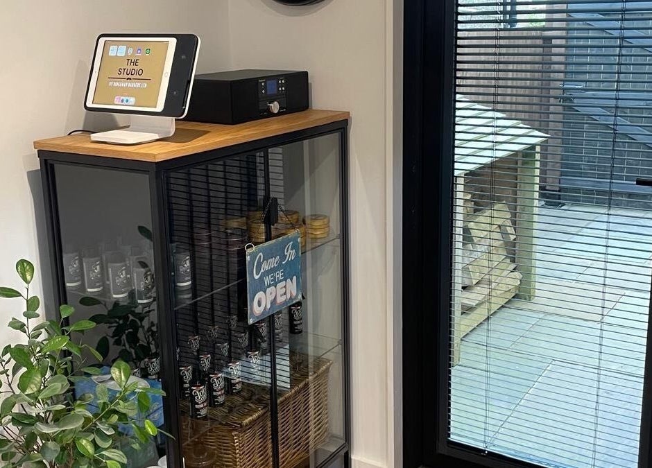 Welcome sign and product display at Ridgeway Barbers, Newport, Wales, GB. Inviting entry view.