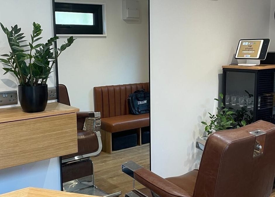 Sleek interior of Ridgeway Barbers in Newport, Wales, GB featuring modern chairs and decor.