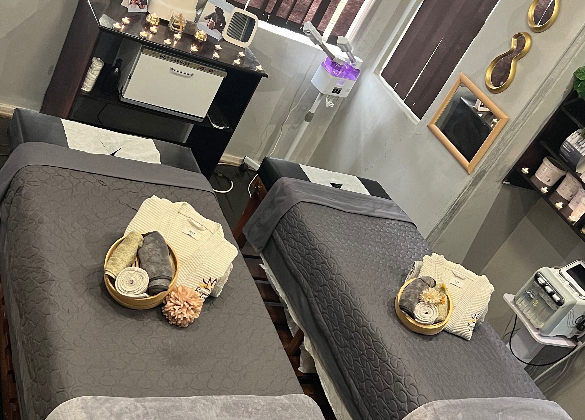 Relaxing treatment room at Pamper Haven Aesthetic Spa, Harare. Features cozy beds and ambient decor.