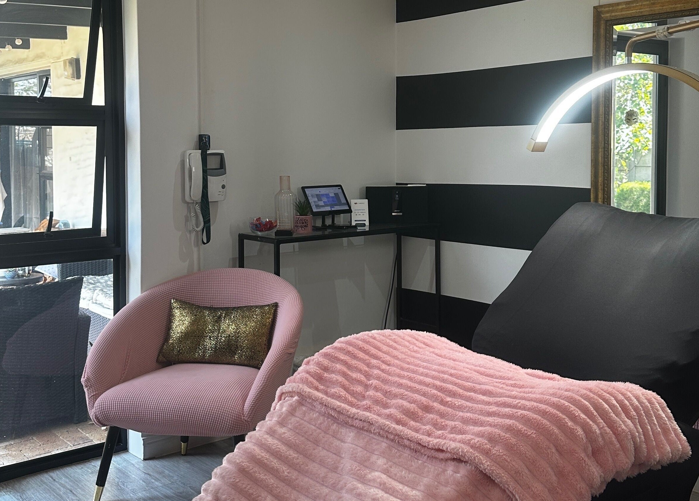Cozy lash room at Yolandie’s Lash Extensions and Aesthetics, Cape Town, Western Cape, ZA with plush pink decor.