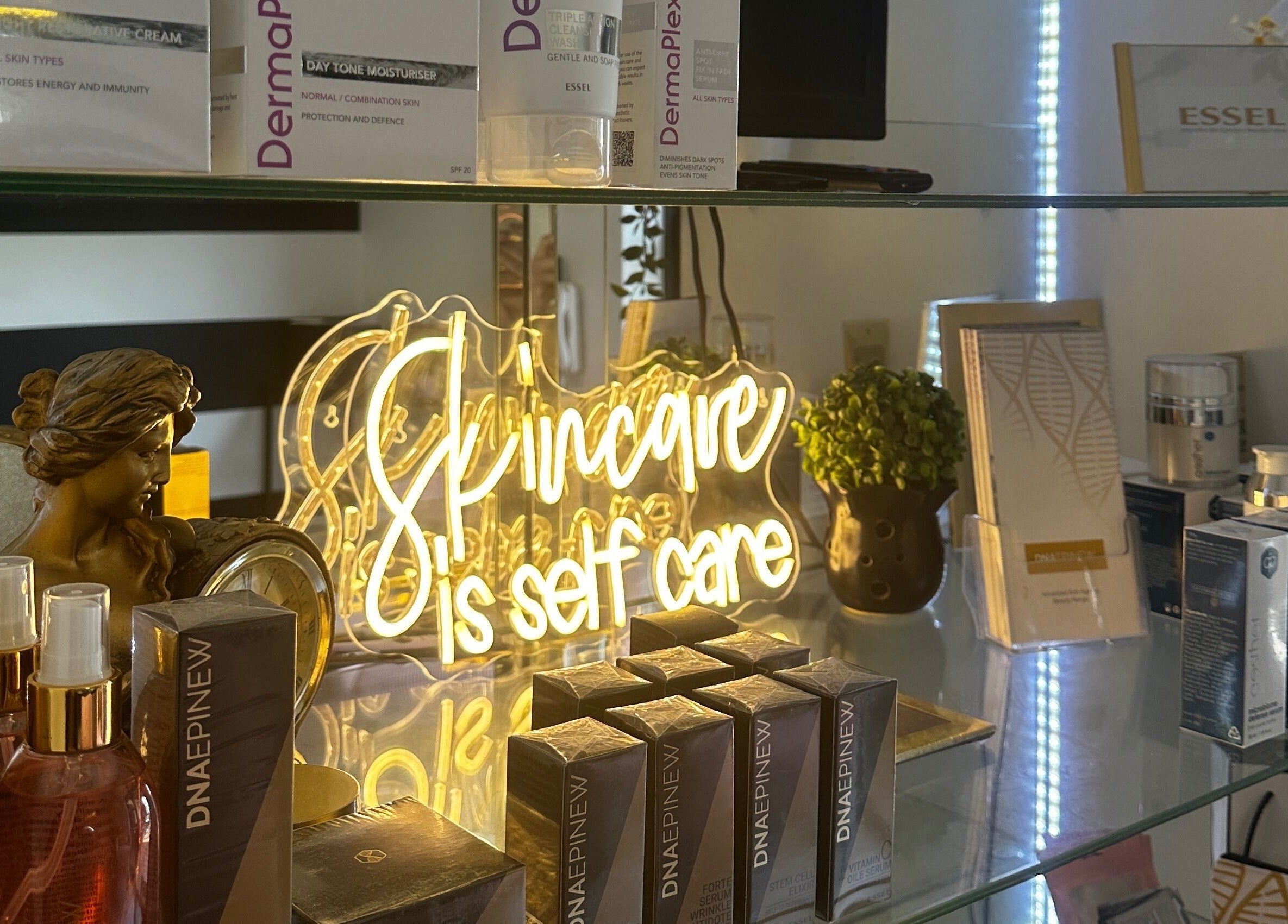 Product display with glowing 'Skincare is self care' sign at Yolandie’s Lash Extensions and Aesthetics, Cape Town.