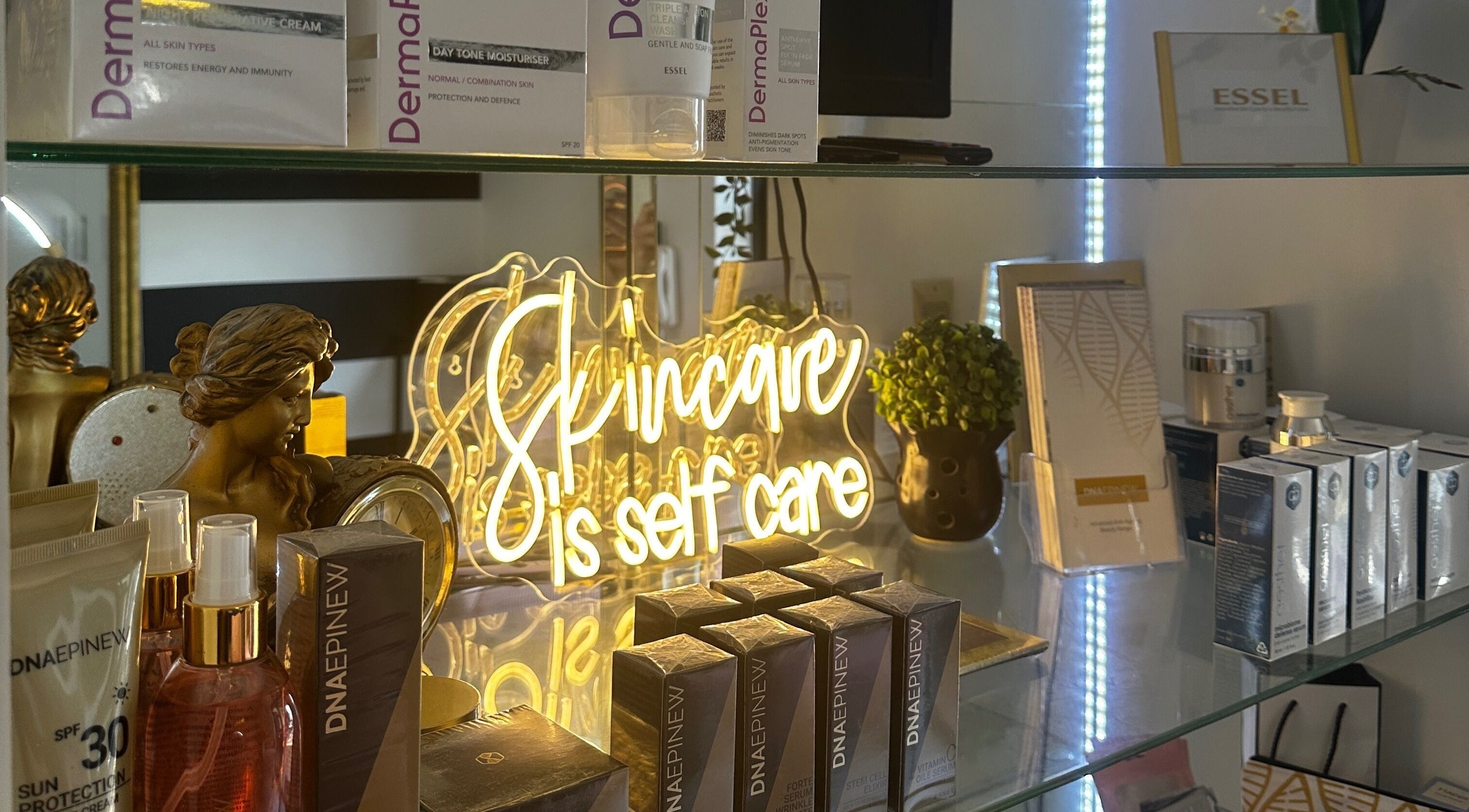 Product display with glowing 'Skincare is self care' sign at Yolandie’s Lash Extensions and Aesthetics, Cape Town.