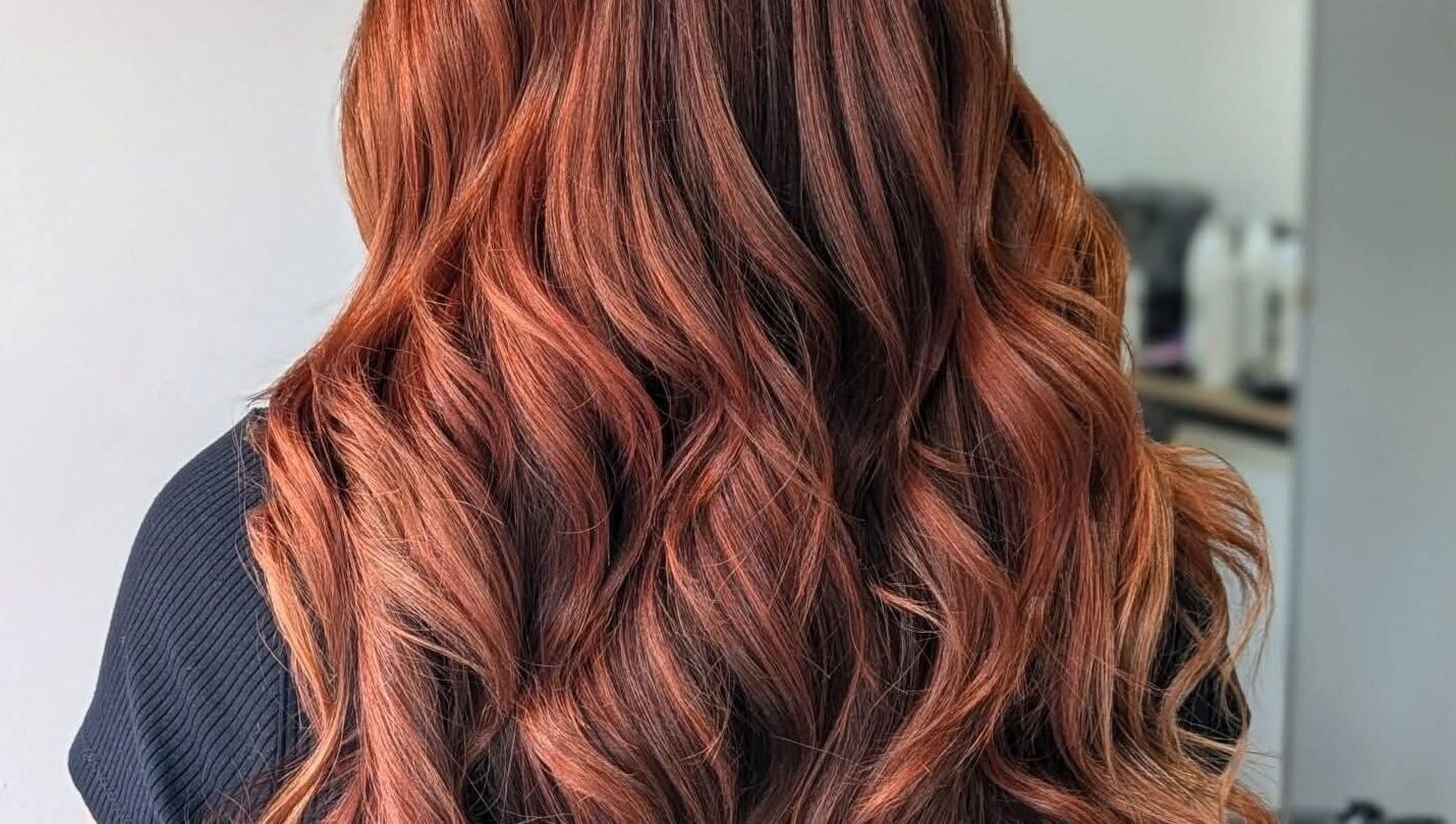 Vibrant copper curls styled at Lizzie Lister Hairdressing, Dingwall, Scotland, GB. Perfect example of salon expertise.