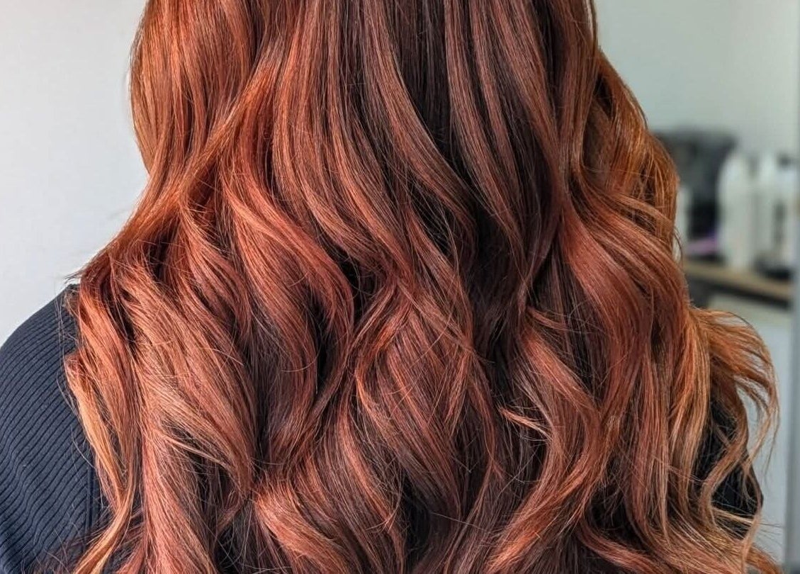 Vibrant copper curls styled at Lizzie Lister Hairdressing, Dingwall, Scotland, GB. Perfect example of salon expertise.