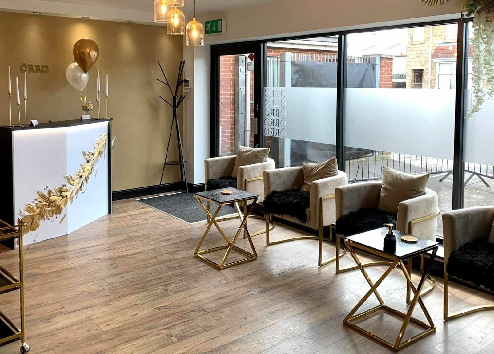 Stylish reception area of Örro Hair and Beauty Salon in Rotherham, England, GB, featuring chic seating.