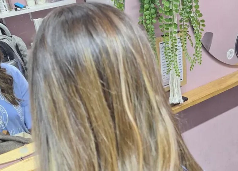 Customer enjoying hair styling at My Hair Department, Cape Town, Western Cape, ZA with lush decor.