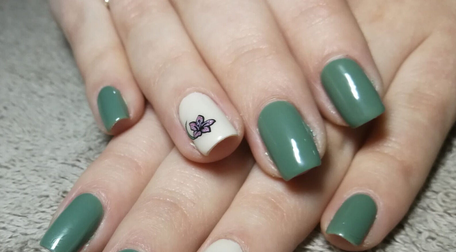 Stylish green manicured nails with floral art at Lotus Beauty Retreat, Tzaneen, Limpopo, ZA.