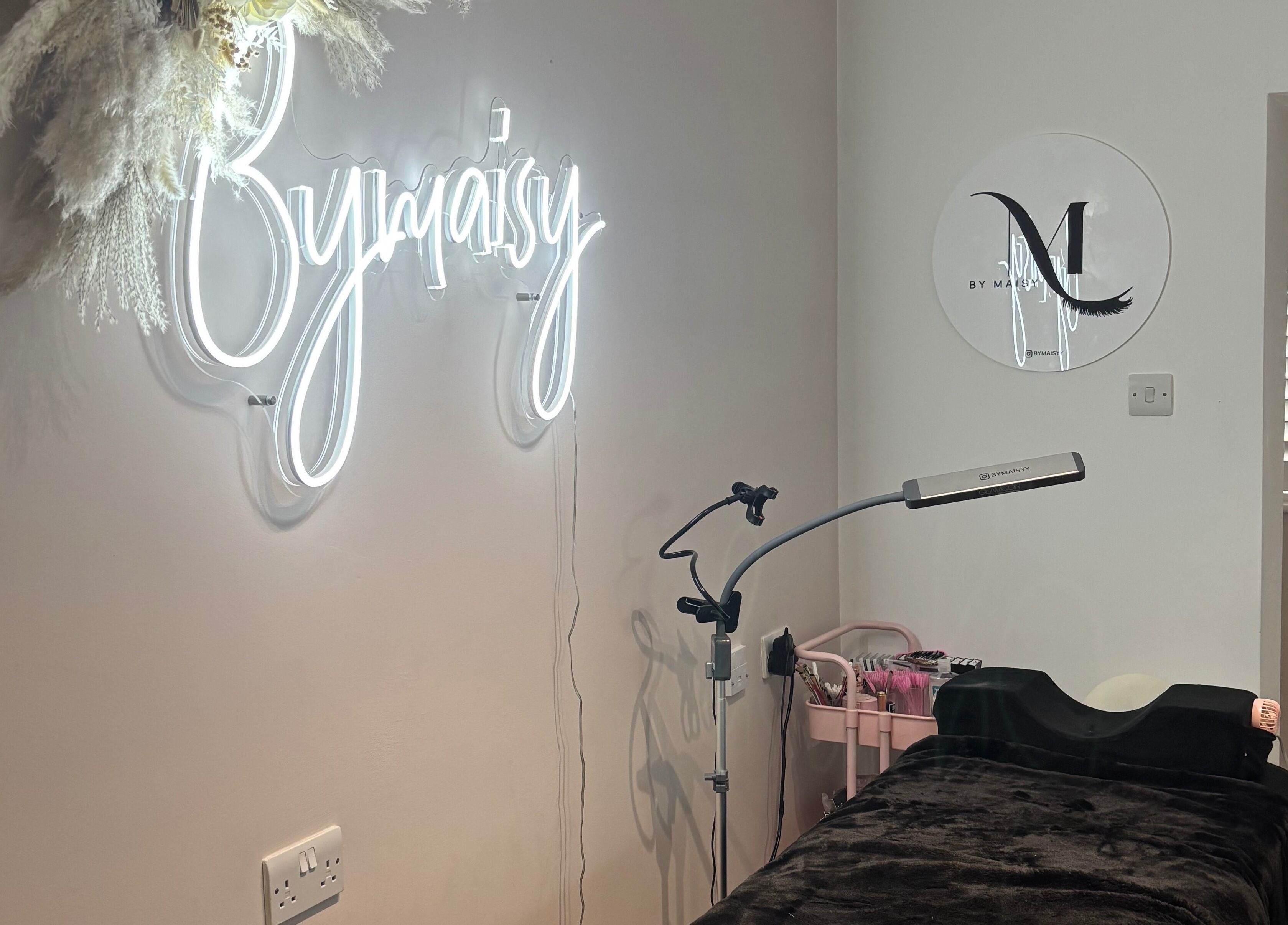ByMaisy beauty room with neon sign and treatment bed in Bexleyheath, England, GB.